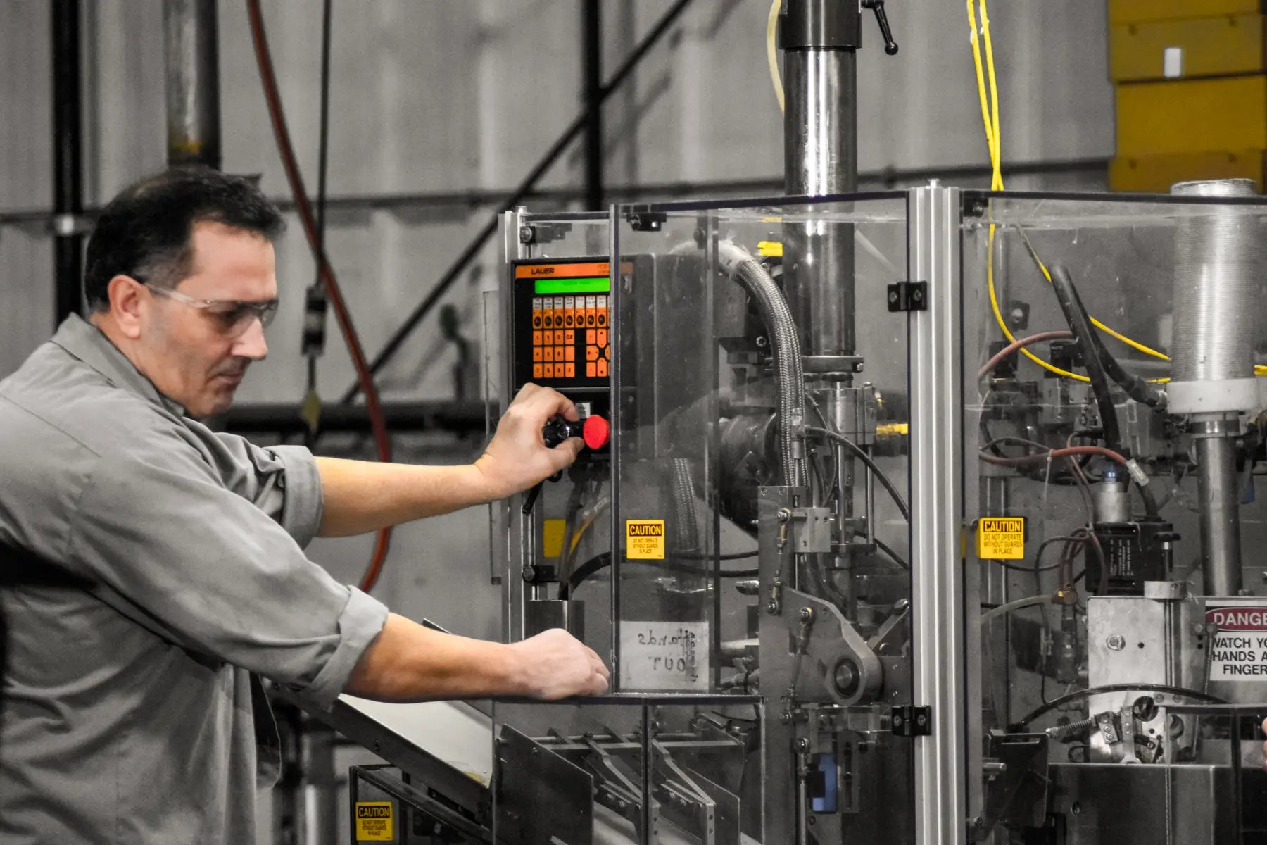 Man at a Machine Working on Manufacturing and Packaging